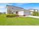 Beautifully landscaped front yard with lush green grass and colorful flower beds at 356 Quarry Rock Cir, Kissimmee, FL 34758