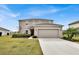Two-story home featuring a well-manicured lawn, a two-car garage, and neutral color palette at 356 Quarry Rock Cir, Kissimmee, FL 34758