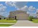 Charming two-story home featuring a spacious two-car garage, lush lawn, and beautiful landscaping at 356 Quarry Rock Cir, Kissimmee, FL 34758