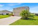 Well-kept two-story home featuring a two-car garage and manicured front lawn at 356 Quarry Rock Cir, Kissimmee, FL 34758