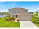 Charming two-story home with a well-maintained lawn and colorful landscaping at 356 Quarry Rock Cir, Kissimmee, FL 34758