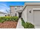 Front entrance to the two-story home with mulch beds, small plants and a walkway at 356 Quarry Rock Cir, Kissimmee, FL 34758