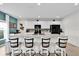The kitchen area has white cabinets and a breakfast bar with four stools at 356 Quarry Rock Cir, Kissimmee, FL 34758