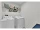 Laundry room with side-by-side washer and dryer, plus shelving above at 356 Quarry Rock Cir, Kissimmee, FL 34758