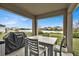 Covered outdoor patio with a view of a lake and neighboring homes at 356 Quarry Rock Cir, Kissimmee, FL 34758