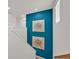 Bright stairway featuring a blue accent wall with modern art and natural light from the window at 356 Quarry Rock Cir, Kissimmee, FL 34758