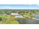 Aerial view showcasing the community clubhouse, pool, golf course, and scenic pond at 3900 Southpointe Dr # 127, Orlando, FL 32822