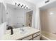 Bright bathroom with a wide mirror, sink, and tub/shower combo at 3900 Southpointe Dr # 127, Orlando, FL 32822