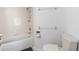 Bathroom featuring a toilet, tub, and shower with white tiles at 3900 Southpointe Dr # 127, Orlando, FL 32822
