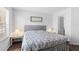 Bright bedroom features a queen bed and wood floors at 3900 Southpointe Dr # 127, Orlando, FL 32822