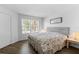 Bright bedroom features a queen bed and wood floors at 3900 Southpointe Dr # 127, Orlando, FL 32822