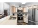 Open kitchen with stainless steel appliances and breakfast bar at 3900 Southpointe Dr # 127, Orlando, FL 32822