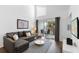 Comfortable living room with a sectional sofa, balcony, and a sleek entertainment center at 3900 Southpointe Dr # 127, Orlando, FL 32822