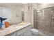 Bright bathroom featuring granite counters, white cabinets and a glass-enclosed shower at 4314 Lana Ave, Davenport, FL 33897