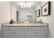 Bright bathroom with double sinks, granite countertop, and large mirror at 4314 Lana Ave, Davenport, FL 33897