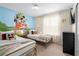 Charming bedroom with twin beds, cartoon character mural, and ample natural light at 4314 Lana Ave, Davenport, FL 33897