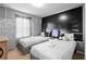 Stylish bedroom featuring two twin beds, unique decor, and themed wallpaper at 4314 Lana Ave, Davenport, FL 33897