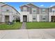 Charming two-story townhome with gray siding and a well-manicured lawn in a desirable neighborhood at 4314 Lana Ave, Davenport, FL 33897