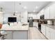 Bright kitchen features white cabinetry, granite counters, and an island with pendant lighting at 4314 Lana Ave, Davenport, FL 33897