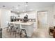 Modern kitchen with an island, granite countertops, stainless appliances, and white cabinetry at 4314 Lana Ave, Davenport, FL 33897