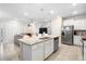 Open-concept kitchen with large island, granite countertops, and stainless steel appliances at 4314 Lana Ave, Davenport, FL 33897