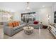 Comfortable living room with stylish sofas, modern decor, and access to outdoor patio at 4314 Lana Ave, Davenport, FL 33897