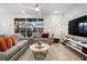 Inviting living room featuring plush sofas, contemporary decor, and screened patio access at 4314 Lana Ave, Davenport, FL 33897