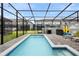 Beautiful screened-in pool with chairs, grill and patio area great for outdoor entertainment at 4314 Lana Ave, Davenport, FL 33897