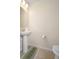 Clean and simple powder room featuring a pedestal sink and neutral tones at 4314 Lana Ave, Davenport, FL 33897