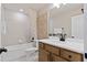 Bright bathroom offers a modern vanity with a soaking tub and shower combination behind at 4564 Maple Waltz Aly, Clermont, FL 34714