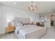 Stylish bedroom features modern lighting, decor, and a padded headboard for a comfortable retreat at 4564 Maple Waltz Aly, Clermont, FL 34714