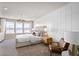 Serene bedroom with panel accent wall, plush bedding, and large windows at 4564 Maple Waltz Aly, Clermont, FL 34714