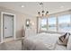 Bright bedroom with large windows, neutral walls, and contemporary light fixture at 4564 Maple Waltz Aly, Clermont, FL 34714