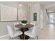 Bright dining area featuring a round table, four chairs, and decorative wall art at 4564 Maple Waltz Aly, Clermont, FL 34714