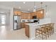 Kitchen with stainless steel appliances, island with seating, and modern pendant lights at 4564 Maple Waltz Aly, Clermont, FL 34714