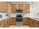 Modern kitchen features stainless steel appliances and light wood cabinets with white tile backsplash at 4564 Maple Waltz Aly, Clermont, FL 34714