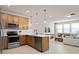 Open kitchen featuring stainless steel appliances and a view to the living room at 4564 Maple Waltz Aly, Clermont, FL 34714