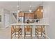 Stylish kitchen island with modern pendant lights, stainless steel appliances, and barstool seating at 4564 Maple Waltz Aly, Clermont, FL 34714