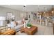 Open-concept living room with comfortable seating, kitchen access, and stylish decor at 4564 Maple Waltz Aly, Clermont, FL 34714