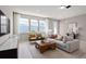 Cozy living room with modern furnishings, large windows, and stylish decor at 4564 Maple Waltz Aly, Clermont, FL 34714