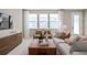 Bright living room featuring a modern sofa, natural light, and stylish decor at 4564 Maple Waltz Aly, Clermont, FL 34714