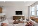 Comfortable living room with stylish furniture, a mounted TV, and plenty of natural light at 4564 Maple Waltz Aly, Clermont, FL 34714