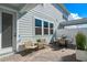 Charming brick patio with outdoor seating, planters, and a bright blue exterior at 4564 Maple Waltz Aly, Clermont, FL 34714