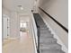 Entryway with staircase and a view into the bright and open living area at 4564 Maple Waltz Aly, Clermont, FL 34714