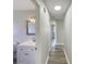 Hallway view of full bathroom with updated vanity, mirror and wood-look floors at 472 Little Aspen Ct, Ocoee, FL 34761