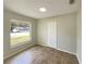 Bright bedroom with wood-look floors, closet and natural light at 472 Little Aspen Ct, Ocoee, FL 34761