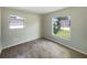 Neutral bedroom with wood look flooring, and view of the front yard through the windows at 472 Little Aspen Ct, Ocoee, FL 34761