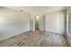 Spacious bedroom with light gray walls, wood look flooring, a window and closet at 472 Little Aspen Ct, Ocoee, FL 34761