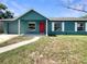 Charming teal house with a red front door, a walkway and a large front yard at 472 Little Aspen Ct, Ocoee, FL 34761
