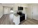 Kitchen has stainless appliances, granite counters, white cabinets, and wood-look flooring at 472 Little Aspen Ct, Ocoee, FL 34761